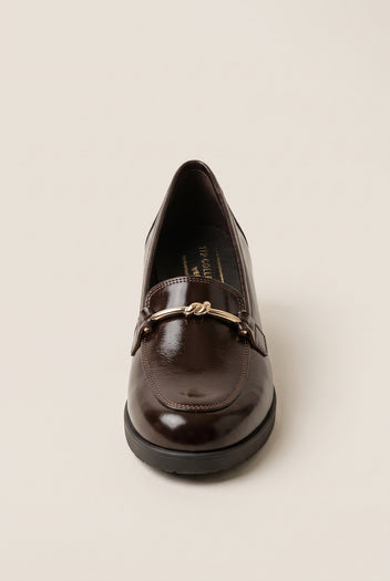 Front view of a brown patent loafer showing its rounded toe and gold horsebit trim on a low sole