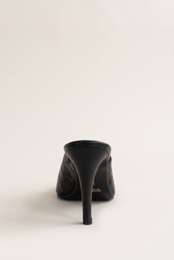 Back view of a black croc-embossed mule showing the tall slim heel and the rounded heel counter