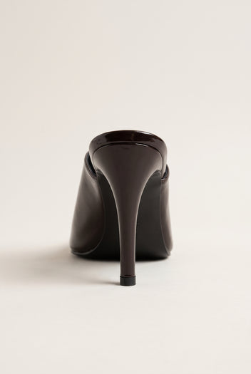 back view of one glossy dark brown patent stiletto mule with a tall slim heel and smooth heel counter