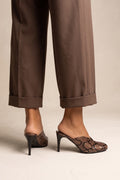 model wearing brown snake print stiletto mules with square toes and brown cuffed trousers