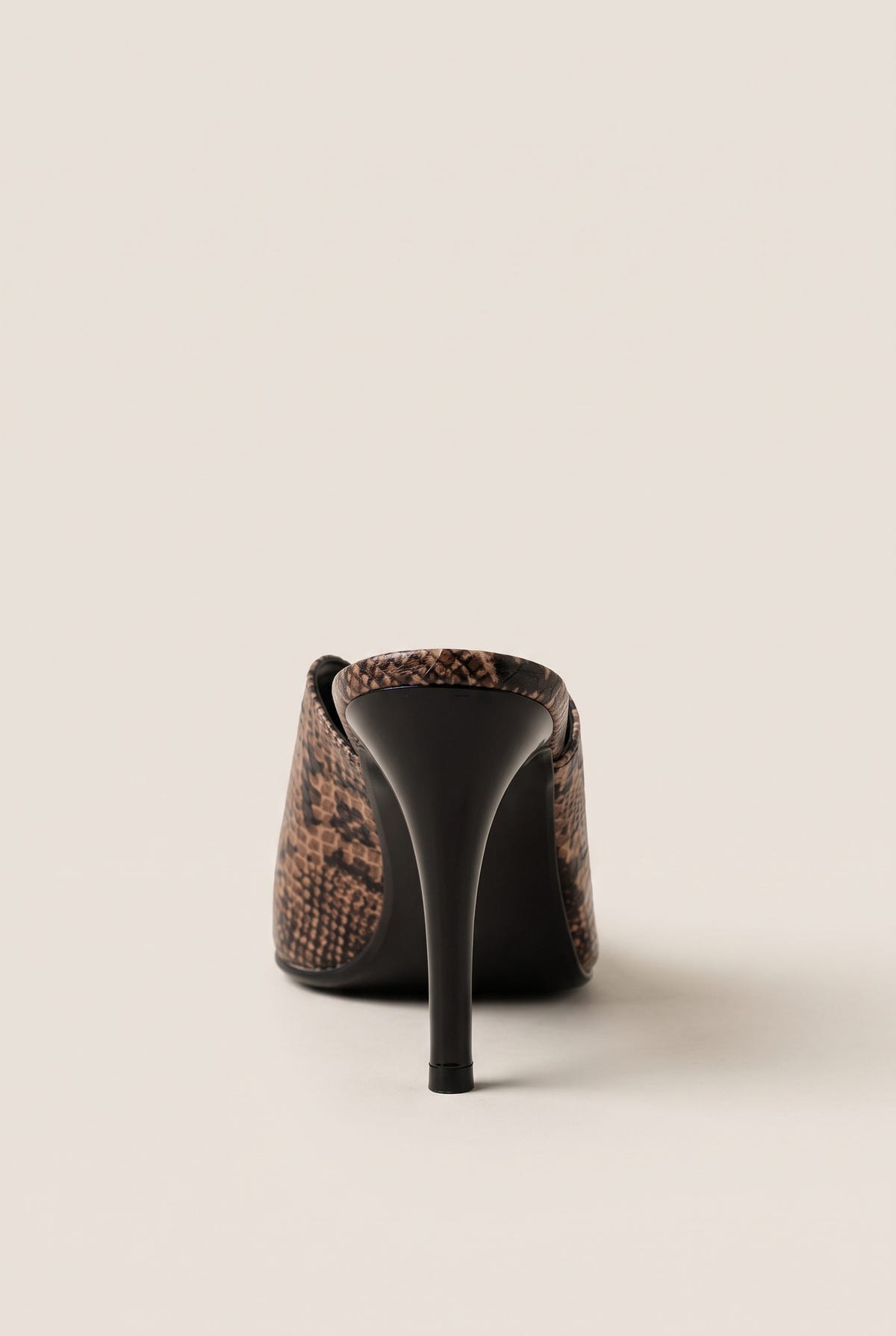 back view of one brown snake print stiletto mule with a tall slim heel and smooth black counter
