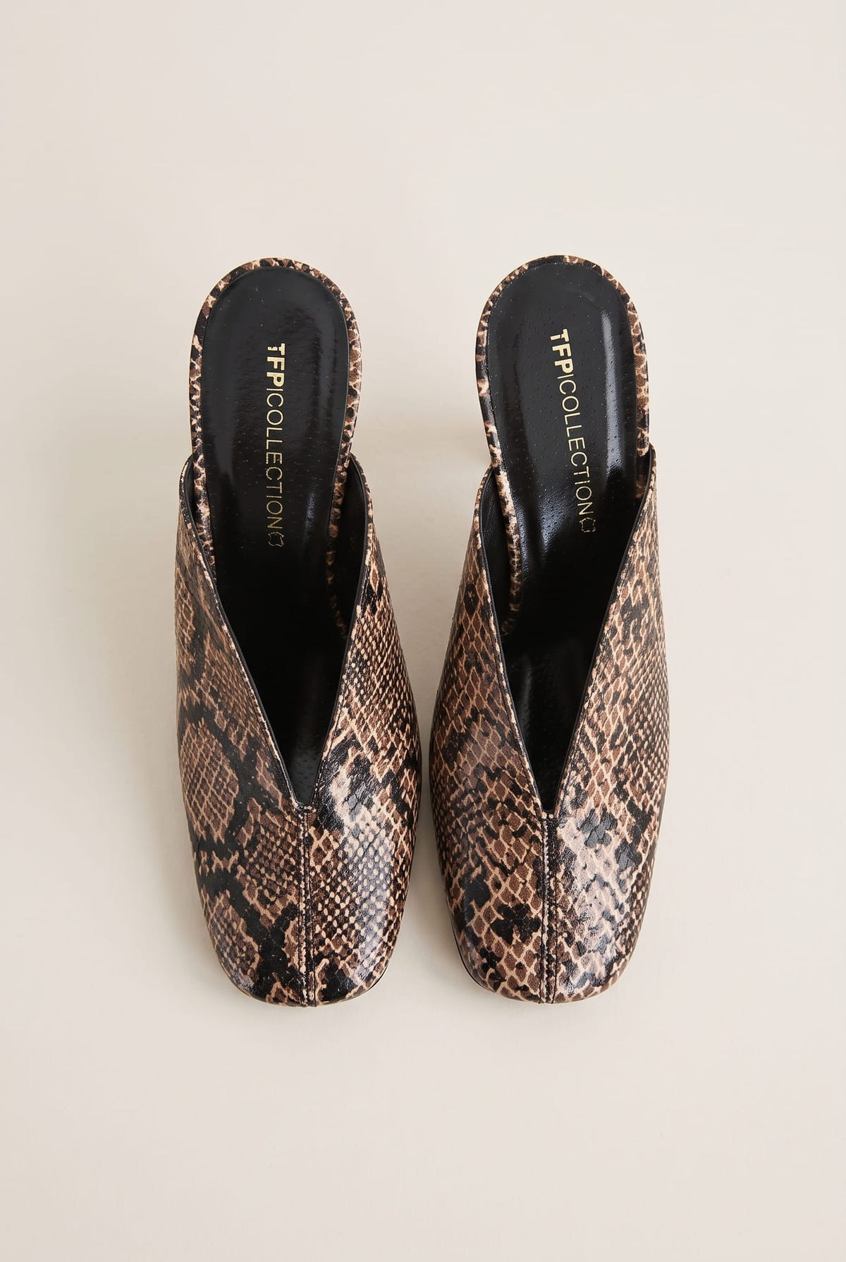 top view of a pair of brown snake print square toe stiletto mules with black insoles