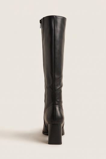 Back view of a black smooth leather knee-high boot with block heel, back seam and side zip at the top