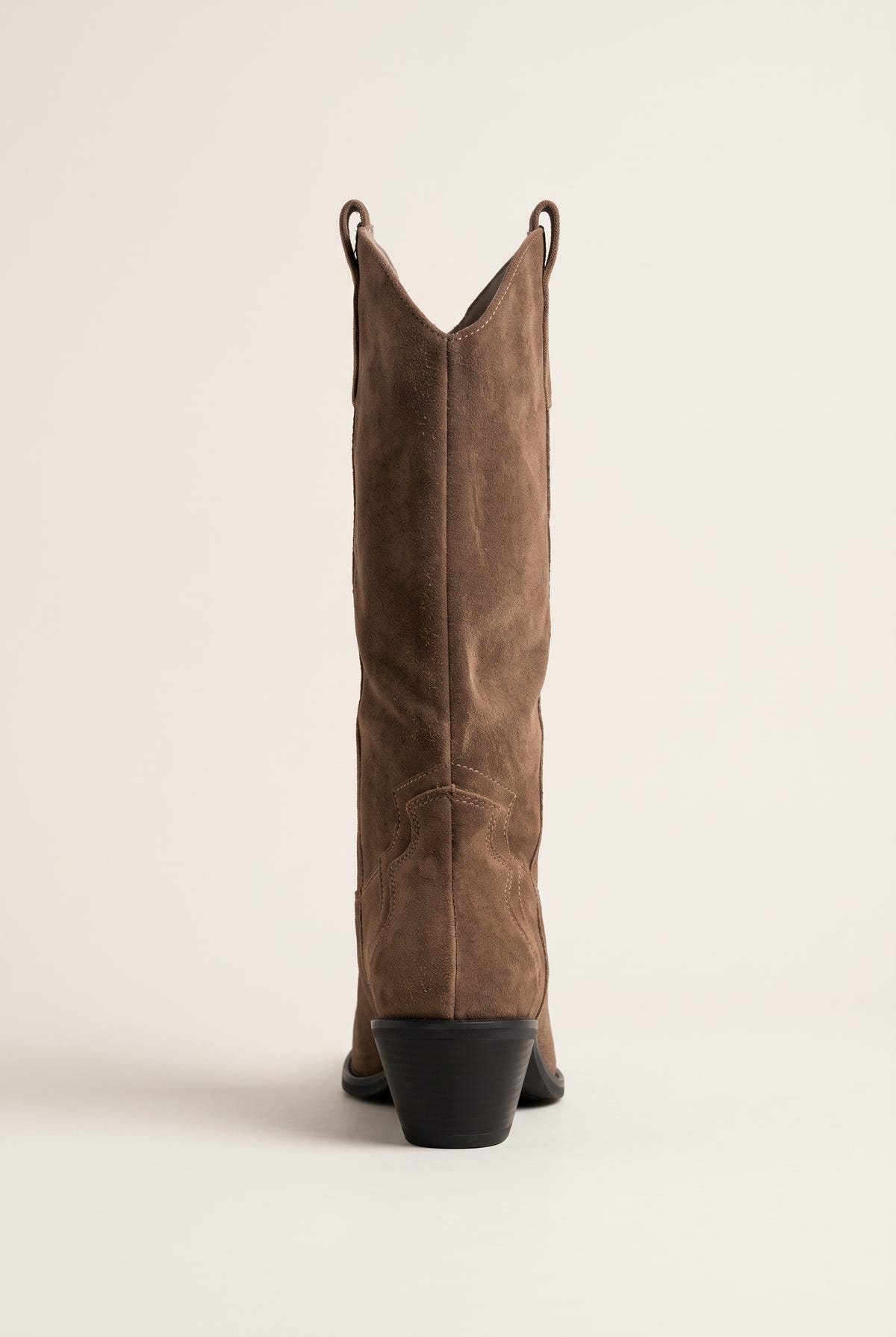 Back view of taupe suede cowboy boot with tall shaft and block heel with dark sole