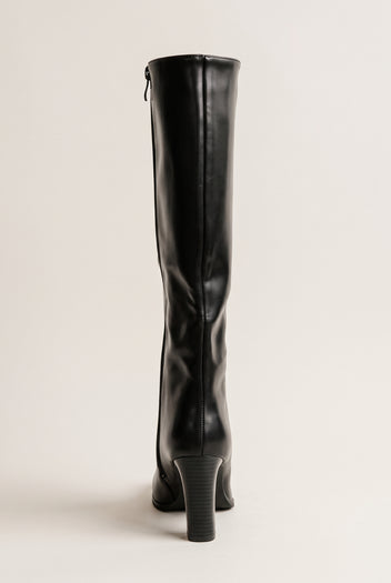 Back view of a black knee-high boot showing the center back seam, the small rear zipper pull near the top and the tapered block heel