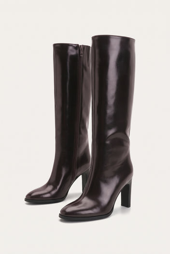 Pair of dark brown knee-high boots side by side at an angle with pointed toes, block heels and smooth glossy leather