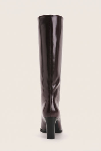 Back view of a tall dark brown knee-high boot showing the central seam and short black block heel