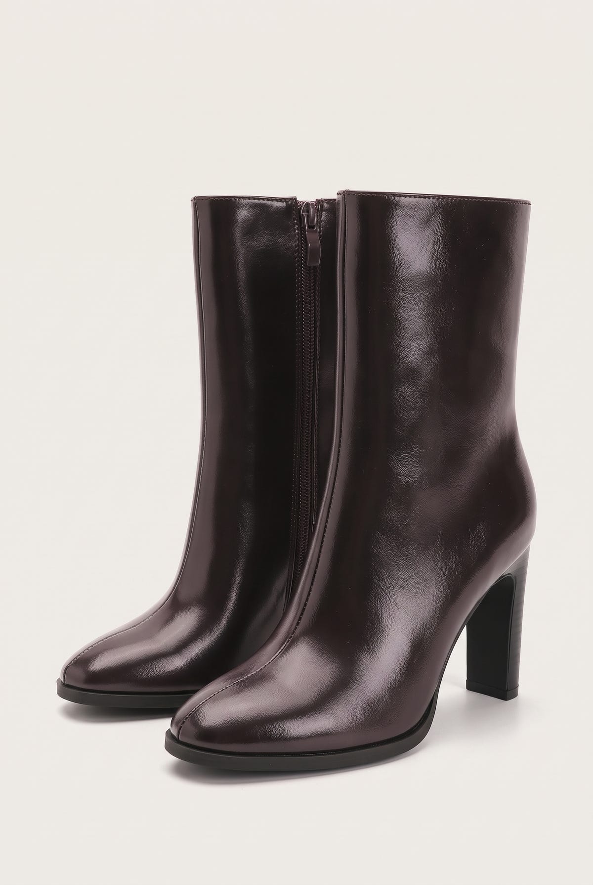 Pair of smooth brown leather pointed-toe ankle boots with side zip and high block heels in three-quarter view