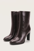 Pair of smooth brown leather pointed-toe ankle boots with side zip and high block heels in three-quarter view
