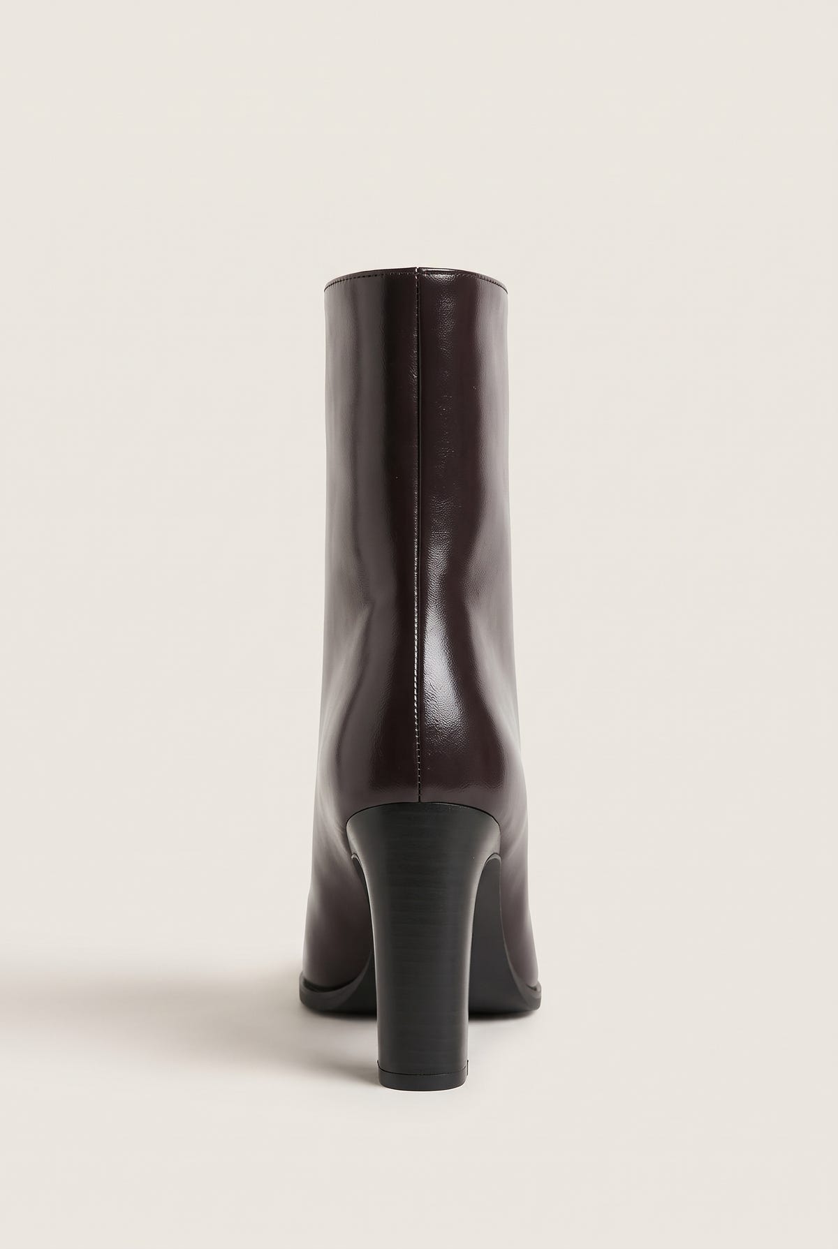 Rear view of brown leather ankle boot with straight shaft, narrow back seam and sturdy block heel