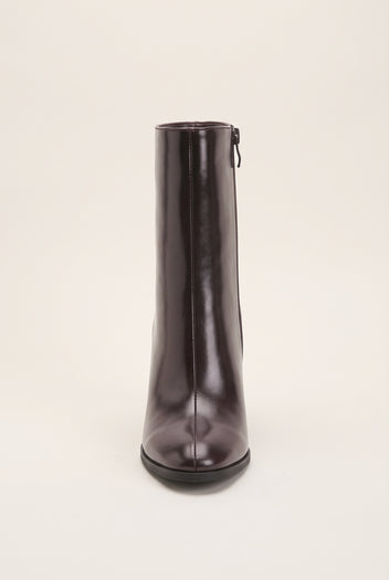 Brown ankle boot seen from the back showing narrow back zip, slim shaft and tall block heel