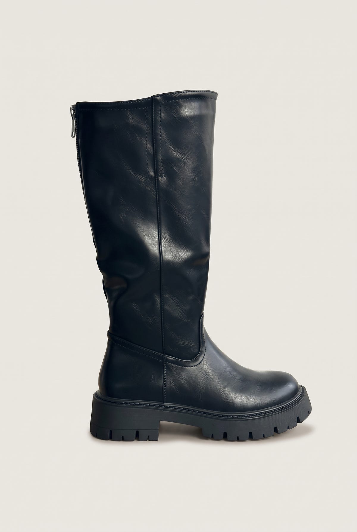 Single black knee-high chunky sole boot in side view showing the tall shaft, rounded toe and thick lug sole