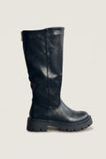 Single black knee-high chunky sole boot in side view showing the tall shaft, rounded toe and thick lug sole
