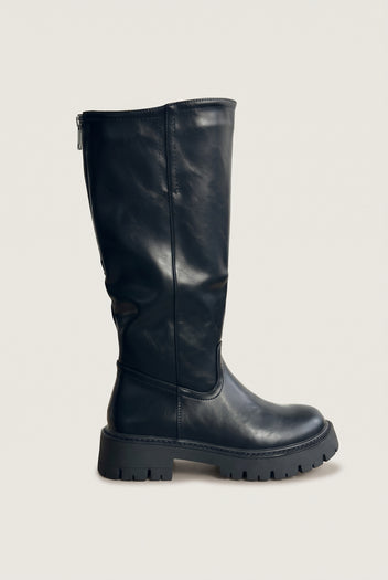 Single black knee-high chunky sole boot in side view showing the tall shaft, rounded toe and thick lug sole