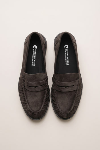 Top view of brown suede penny loafers with stitched rounded toes and padded insoles