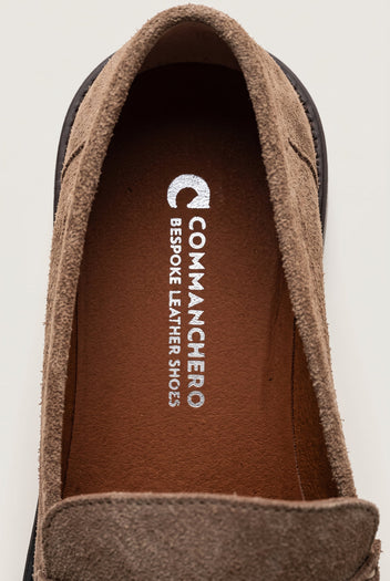 Close-up of beige suede loafer collar and tan leather insole with a dark rim on the sole