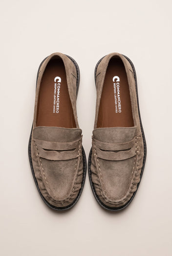 Top view of beige suede penny loafers with stitched rounded toes and cushioned tan insoles