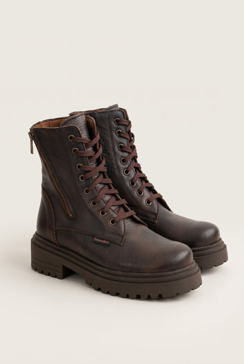Angled pair of brown matte combat boots with laces, rounded toes and rugged lug soles