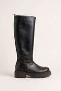 Side view of dark brown matte knee-high boot with chunky lugged sole and back zipper