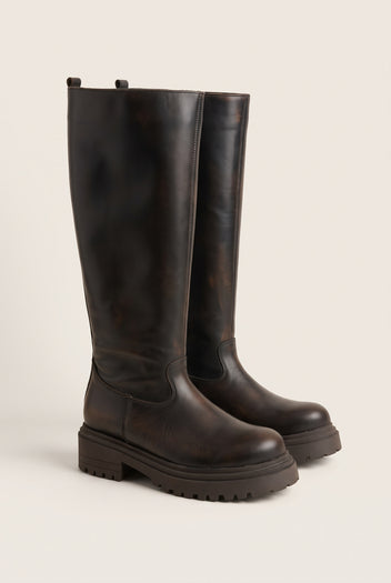 Angled pair of dark brown matte knee-high boots with chunky soles and rounded toes