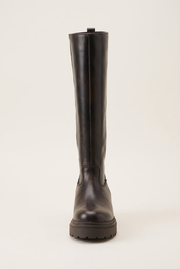 Front view of dark brown matte tall boot with narrow shaft and chunky lugged sole
