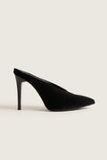 Side view of a single black velvet pointed toe mule with a tall slim stiletto heel