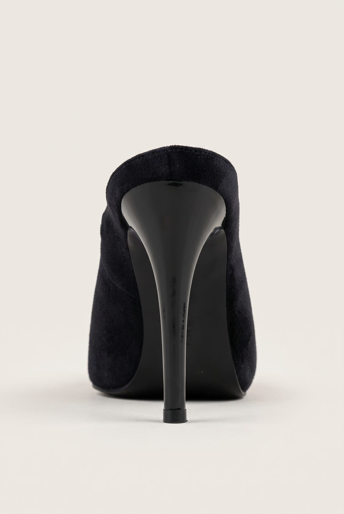 Back view of a black velvet stiletto mule showing the rounded heel counter and tall slim heel
