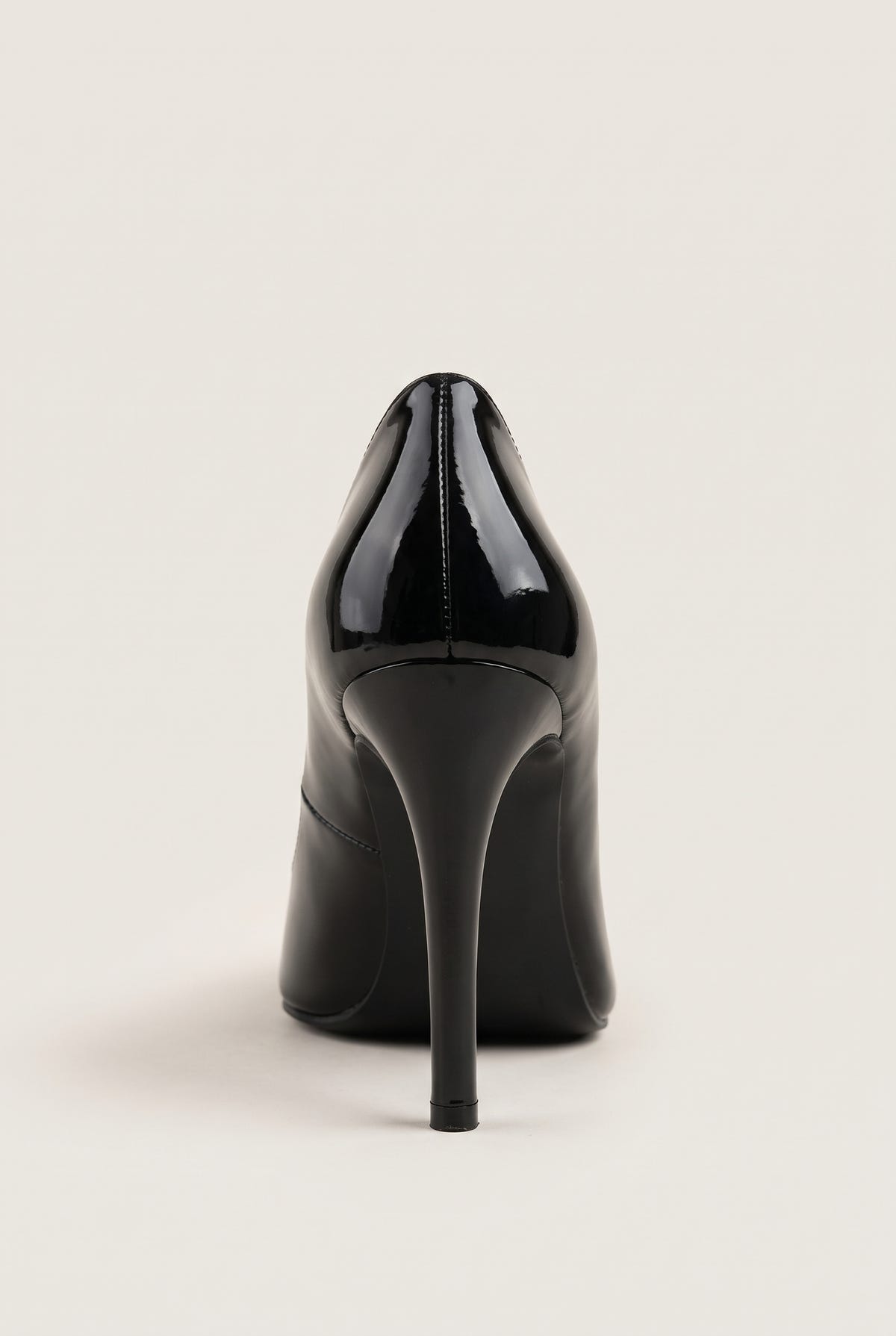 Back view of a black patent pointed-toe pump with a tall stiletto heel and smooth glossy heel counter
