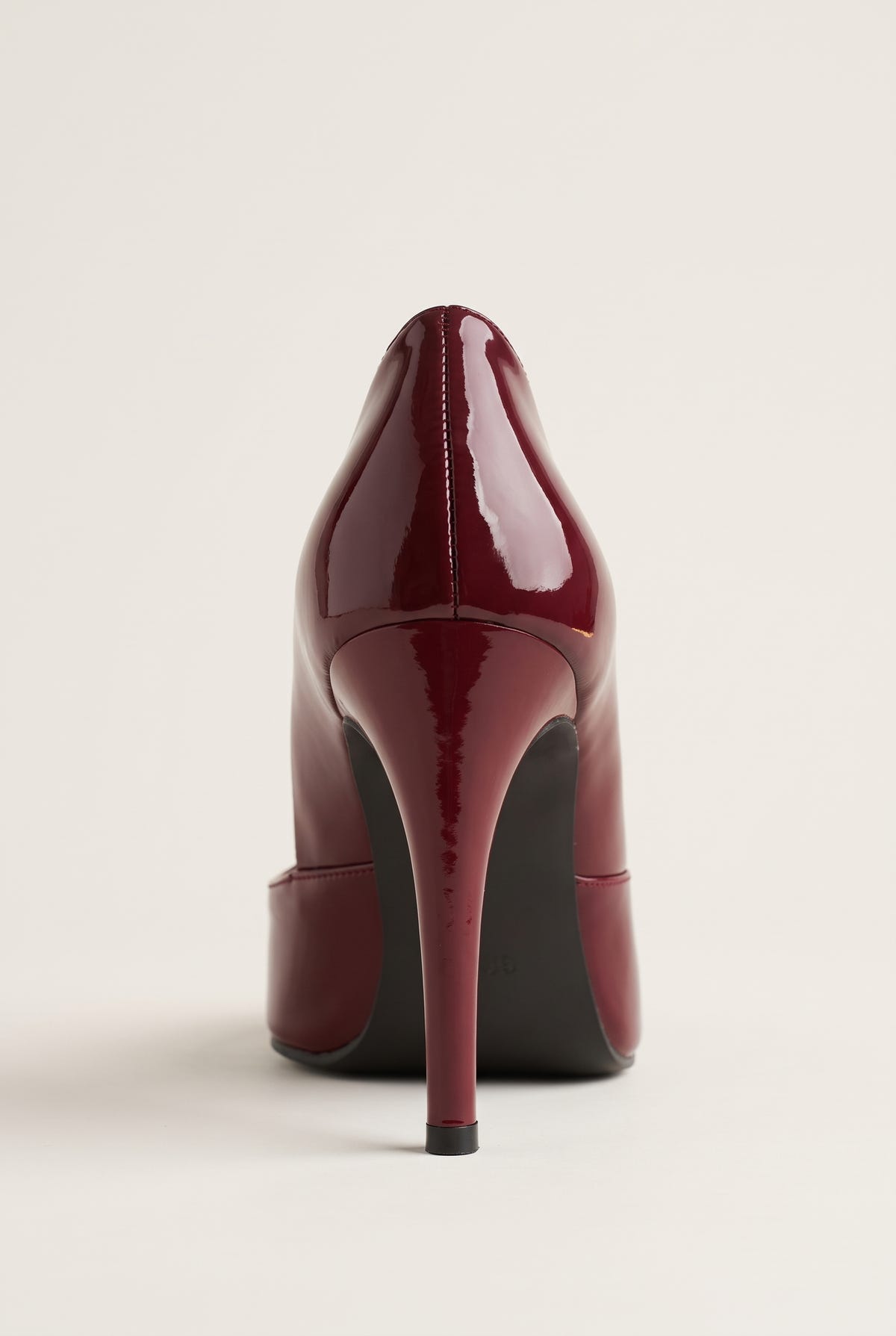 Back view of a bordeaux red patent pump showing the high stiletto heel and smooth curved heel counter