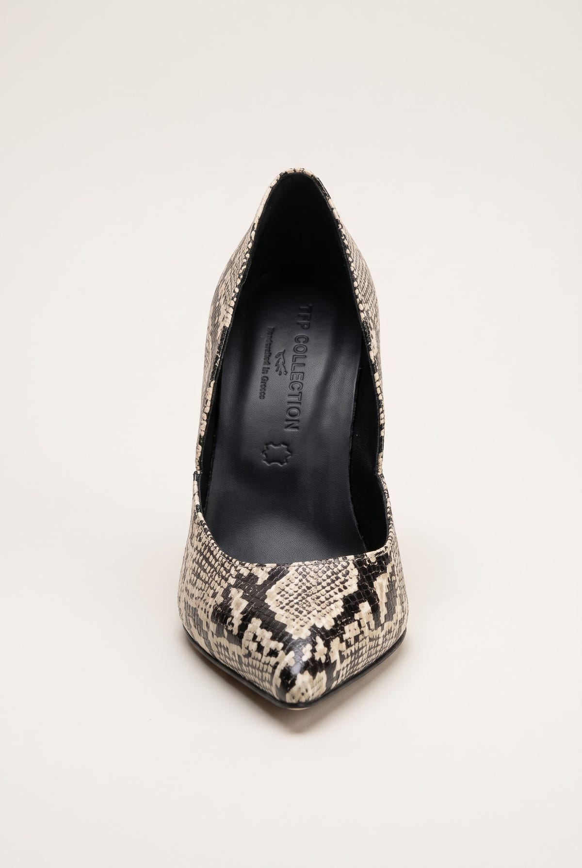 Front view of an ivory and black snake-print pump with a narrow pointed toe and dark interior