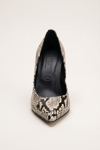 Front view of an ivory and black snake-print pump with a narrow pointed toe and dark interior