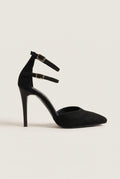 Single black suede pointed toe pump with double ankle straps and gold buckles, side view showing the stiletto heel