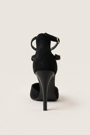 Back view of black suede stiletto pump with crossed ankle straps and gold buckle rising above the heel