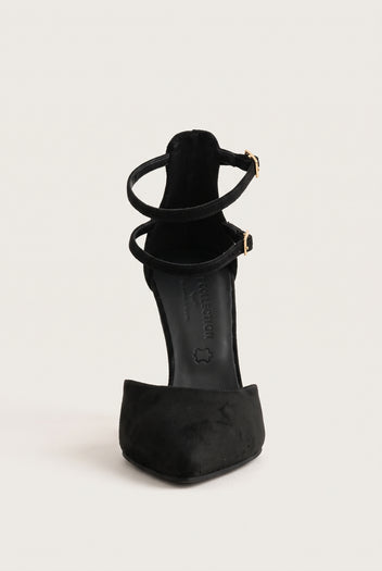 Rear view of black suede pointed pump with thin ankle straps and gold buckles above the slim stiletto heel