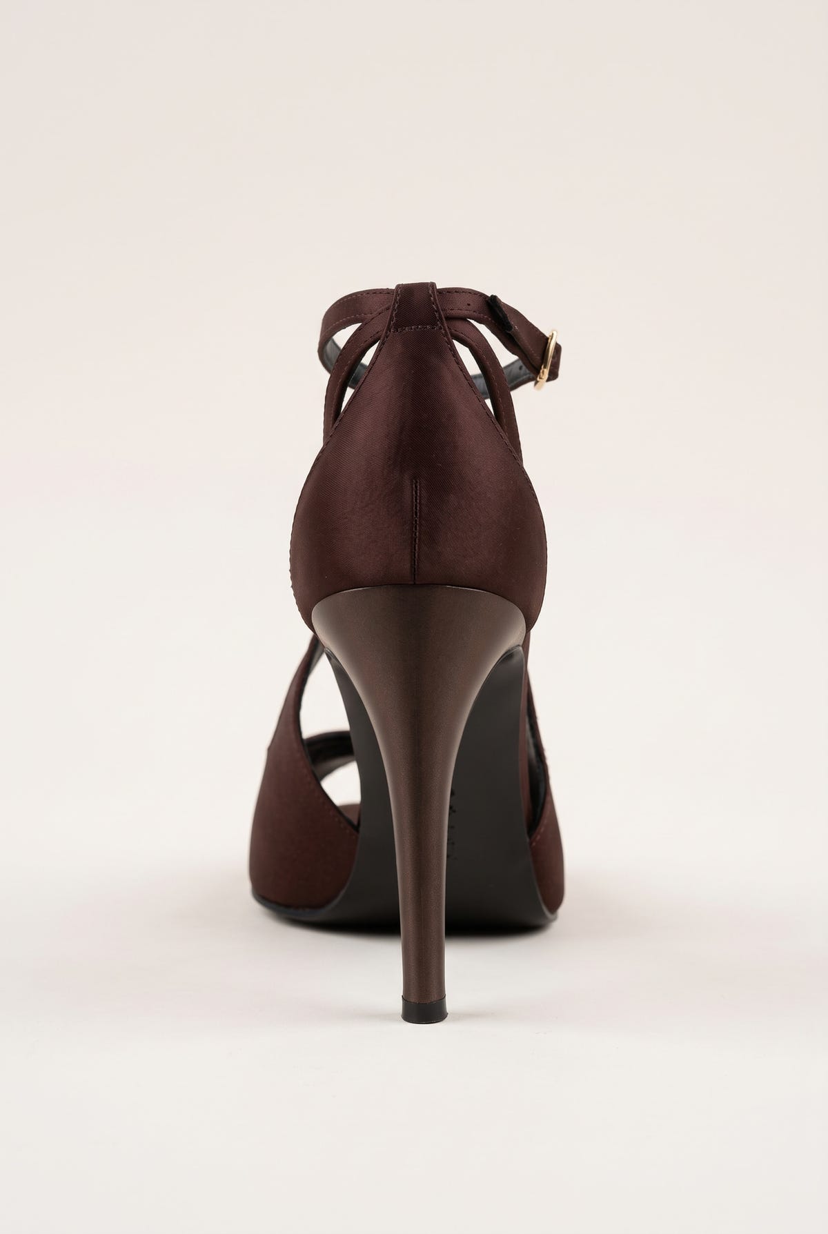 Back view of a brown satin ankle-strap pump with crossed straps at the heel and a tall stiletto heel