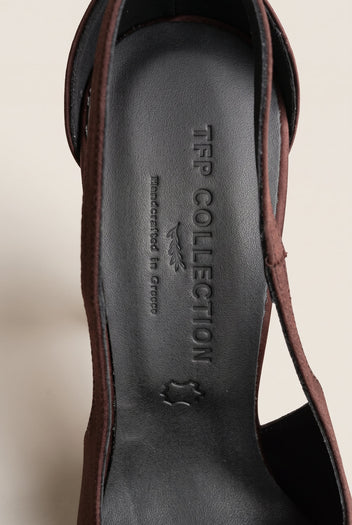 Close-up of a brown satin strap and the black leather insole inside a pointed-toe pump