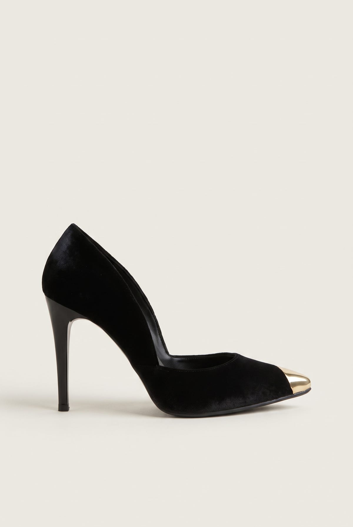 Side view of a black velvet pump with a cut-away side, a gold metal toe cap and a tall slim heel