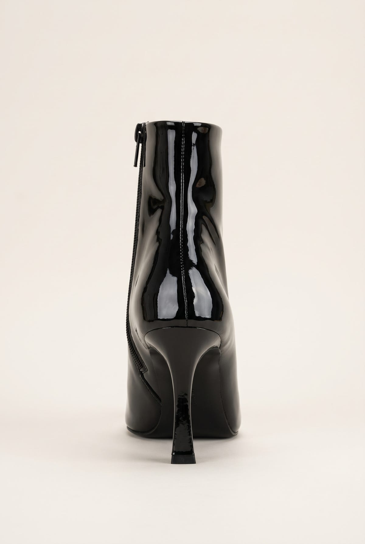 Back view of black patent ankle boot showing the rear zip and tall stiletto heel