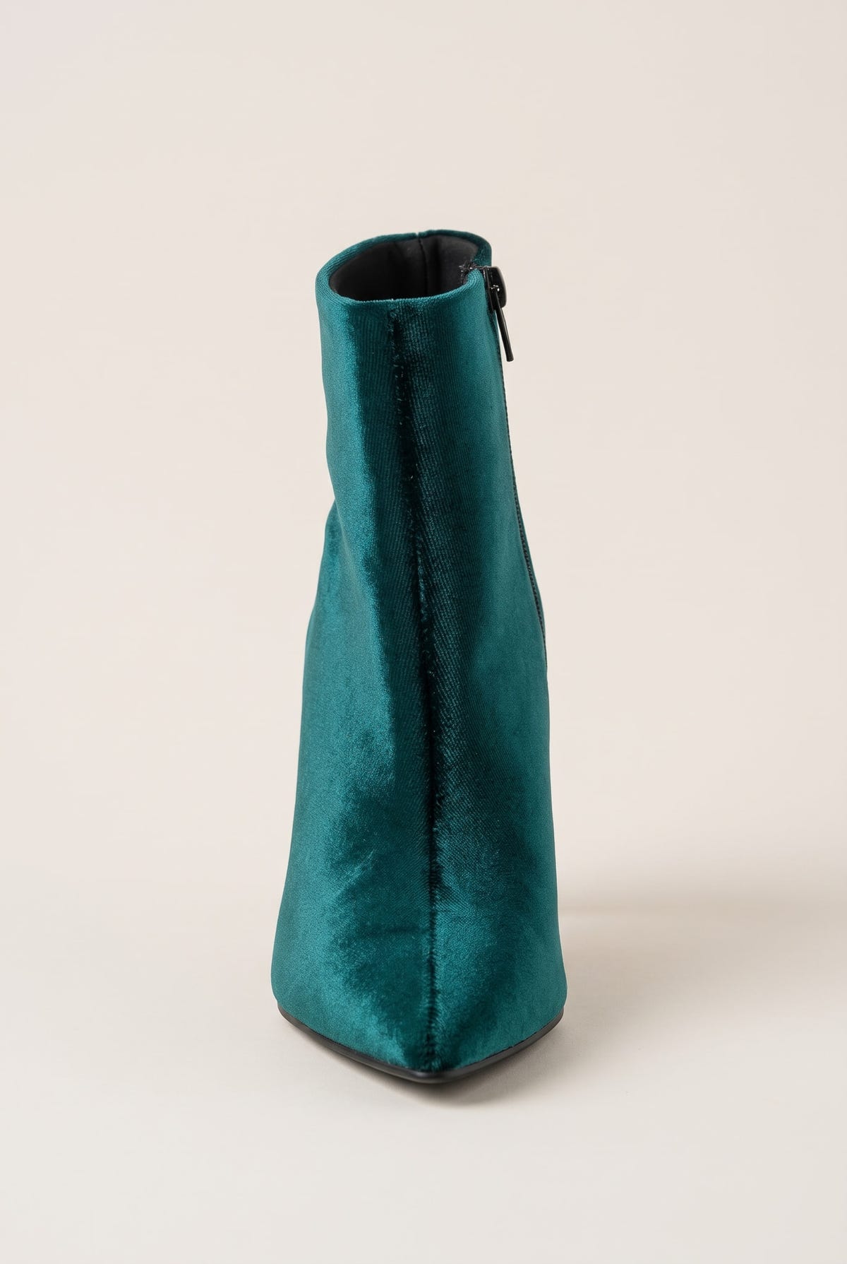 Dark green velvet ankle boot seen from the toe end showing the narrow pointed tip and zip on the shaft