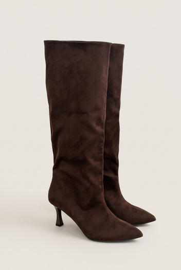 Pair of brown suede knee-high stiletto boots with pointed toes and a slouchy shaft, front three-quarter view
