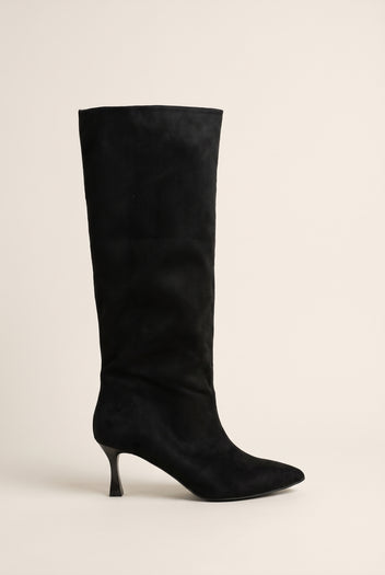Black suede knee high stiletto boot with pointed toe and slim straight shaft in side view on a light surface