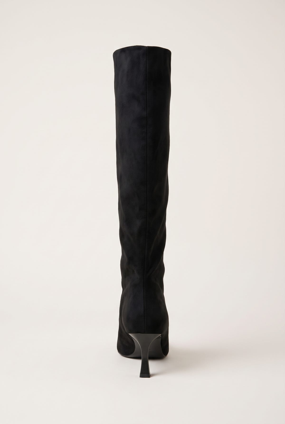 Back view of black suede knee high stiletto boot showing the slim heel and sole at the base