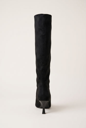 Back view of black suede knee high stiletto boot showing the slim heel and sole at the base