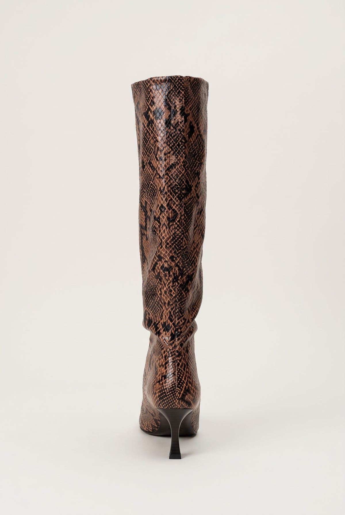 Back view of brown snake print knee-high boot with textured reptile pattern and narrow heel