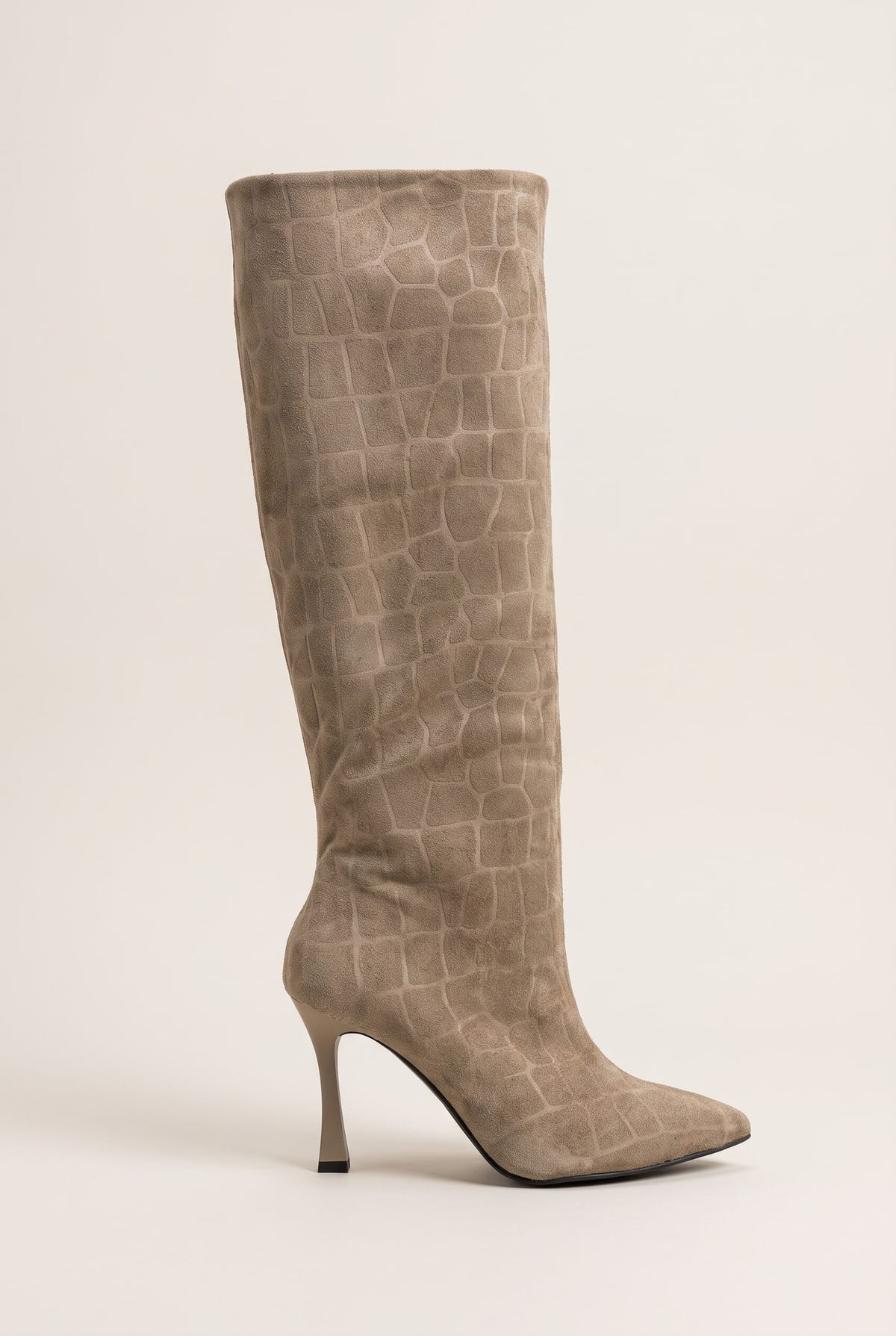Full view of a knee-high beige croc-embossed suede boot with a pointed toe and a slim stiletto heel