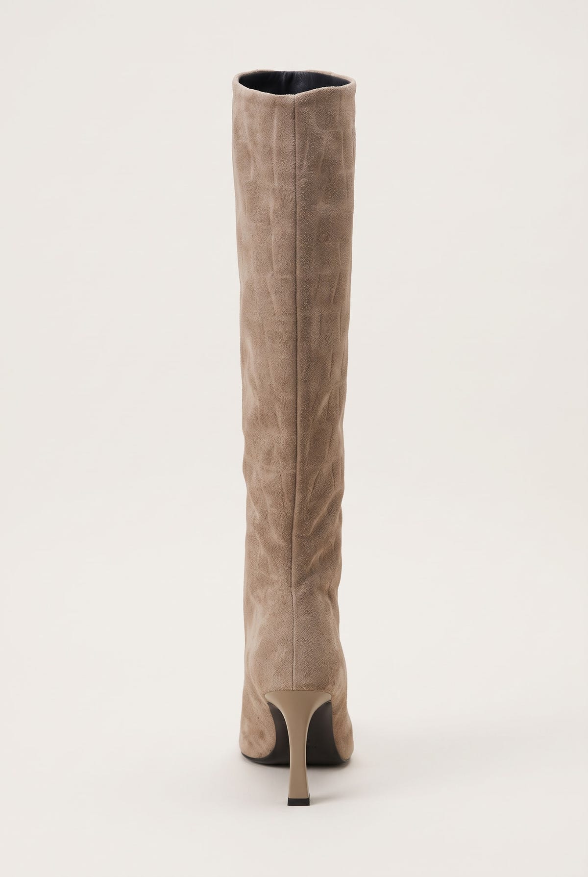 Back view of a knee-high beige suede boot showing the tall straight shaft and slim stiletto heel