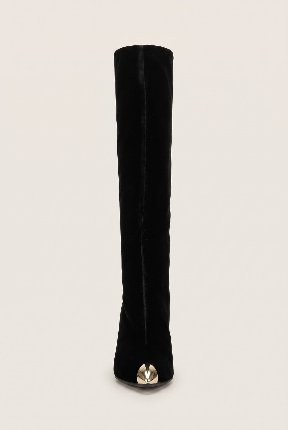 Front view of black velvet knee high boot with a pointed toe and gold tone metal cap at the tip