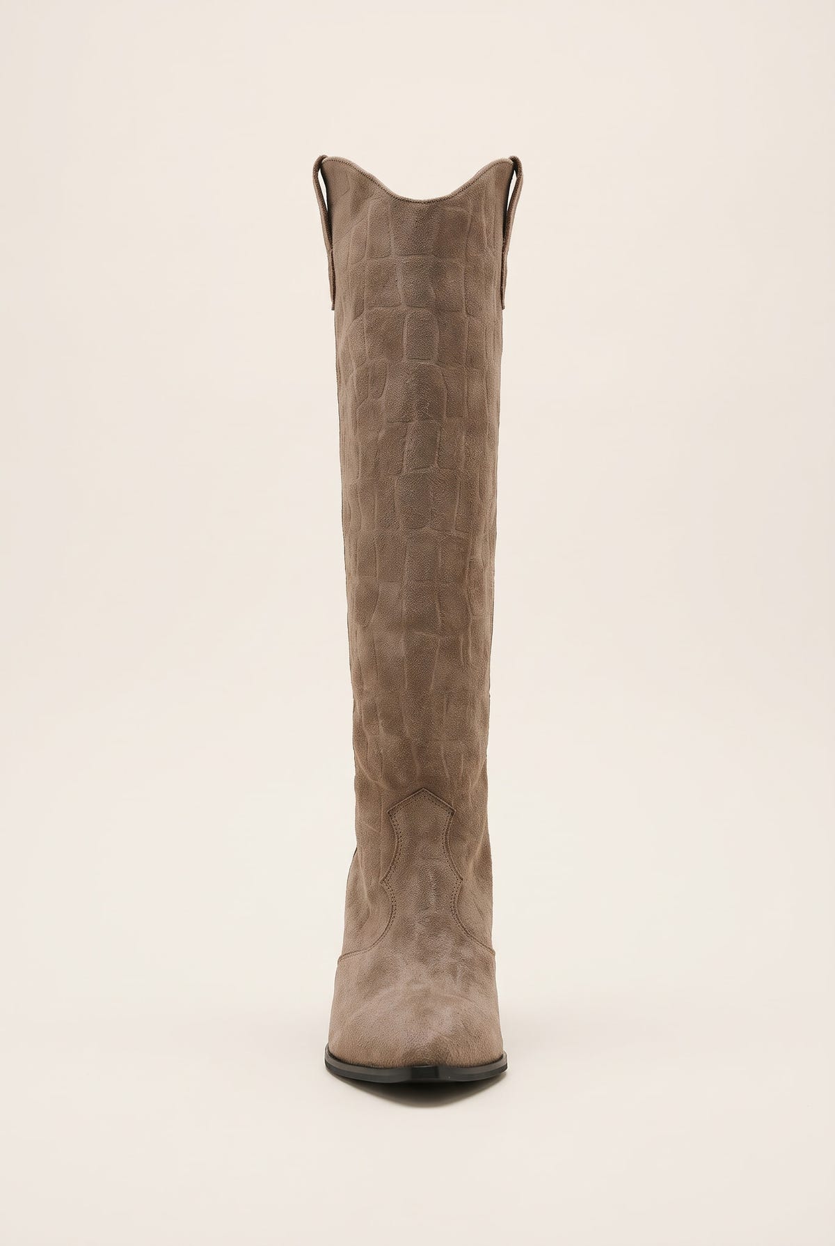 Front view of beige croc suede cowboy boot showing the notched V top edge and pointed toe