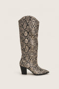 Ivory and black snake print cowboy boot with stacked heel and pointed toe in side view on a light surface