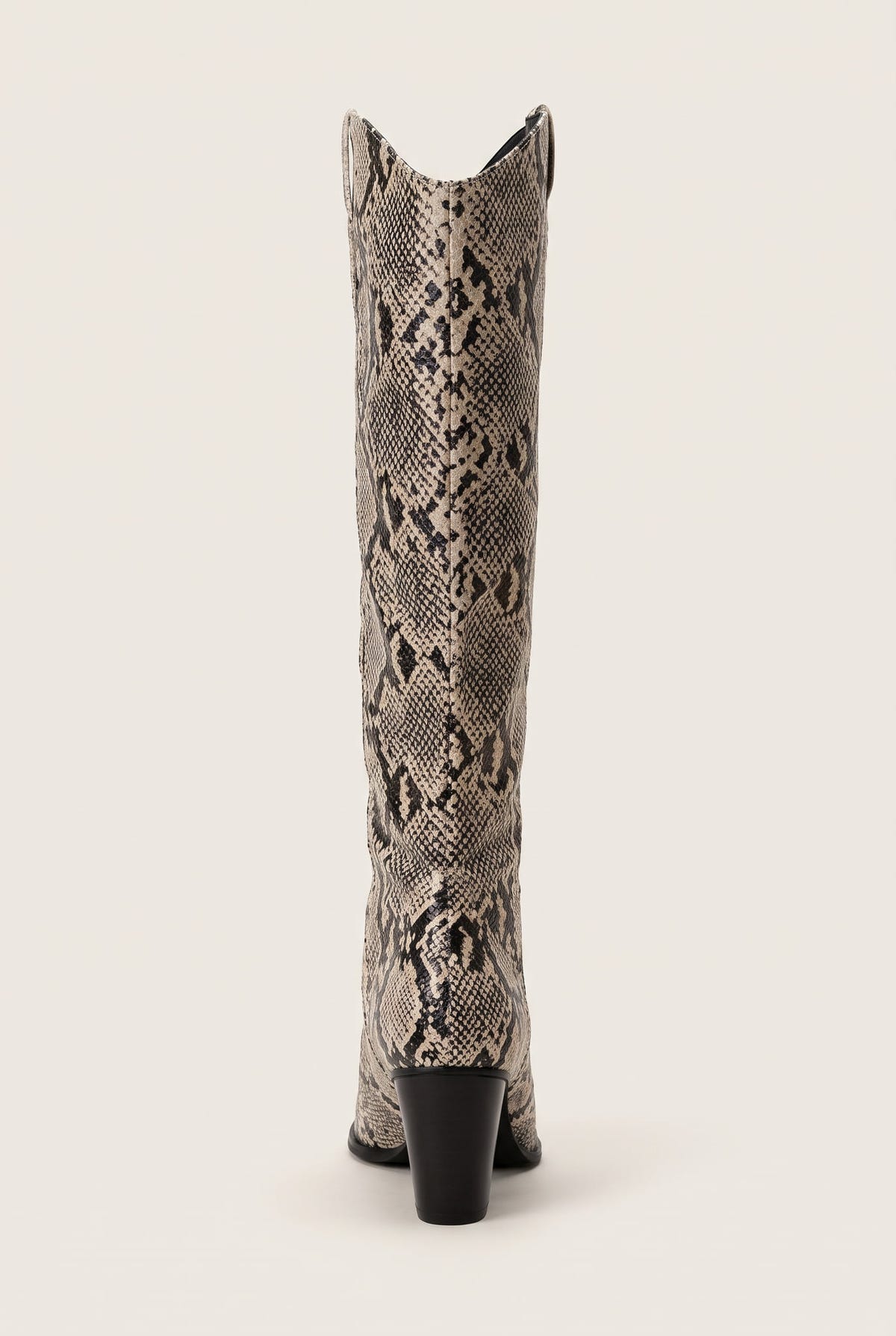 Rear view of ivory and black snake print cowboy boot showing the stacked heel and notched top edge